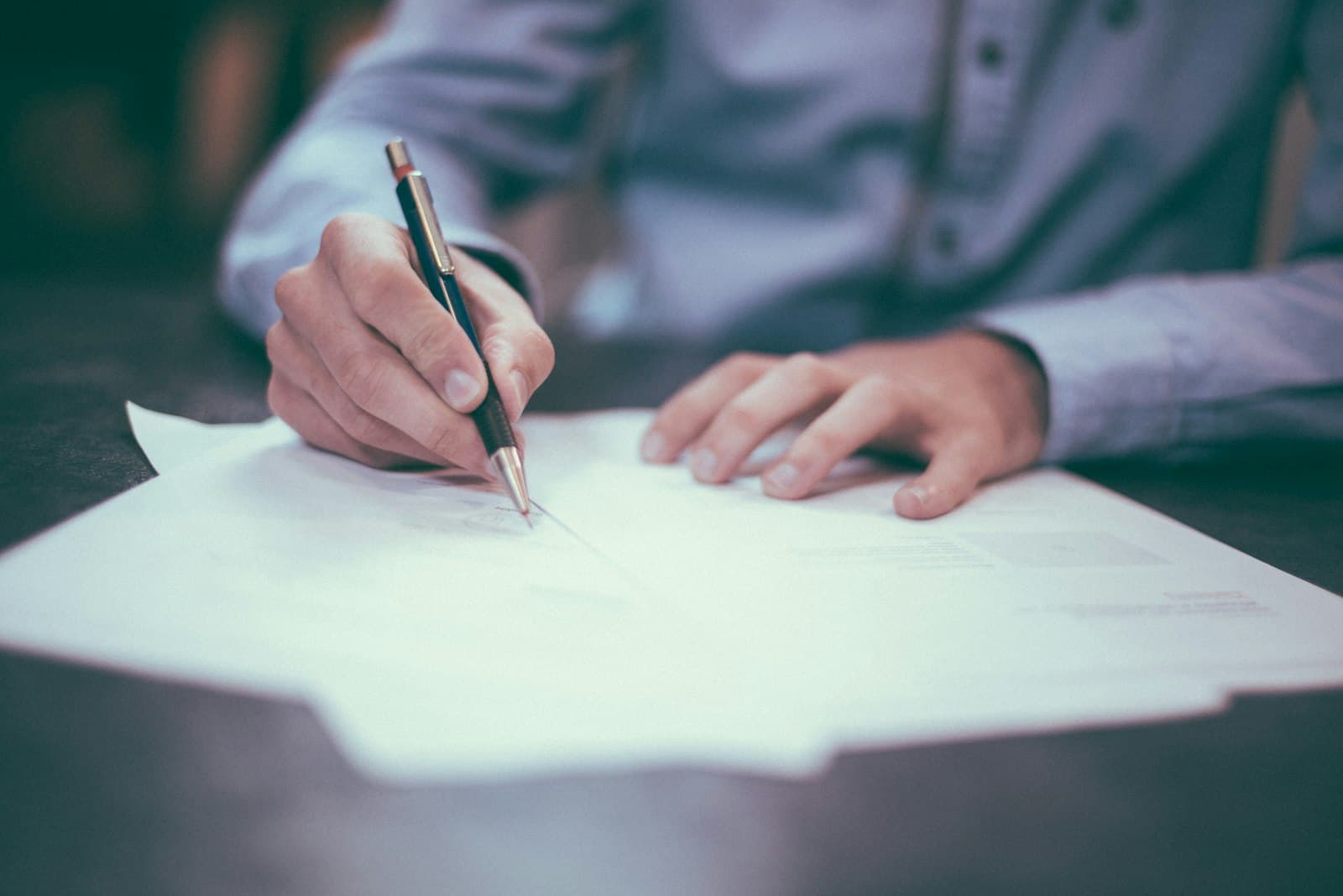 A person signing a paper form