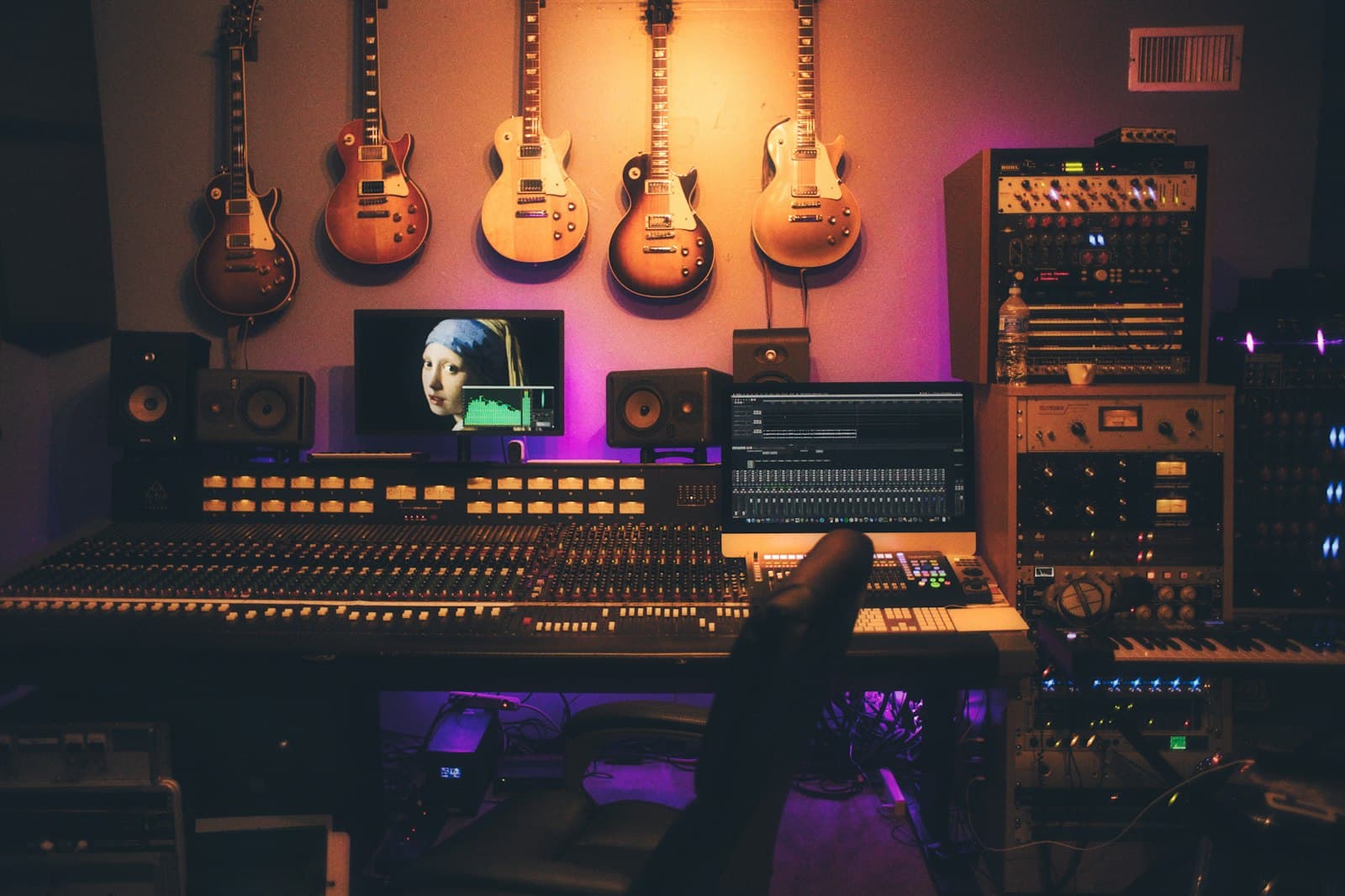 A mixing desk and monitors in a recording room